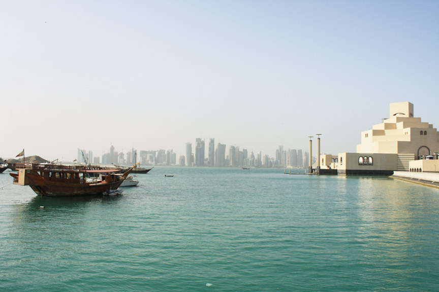 In the shallow, calm waters off the Corniche are a few remaining Qatari dhow boats, the IM Pei-designed Museum of Islamic Art, on the right, and in the distance across the lagoon, the ultra-modern high rises of West Bay.