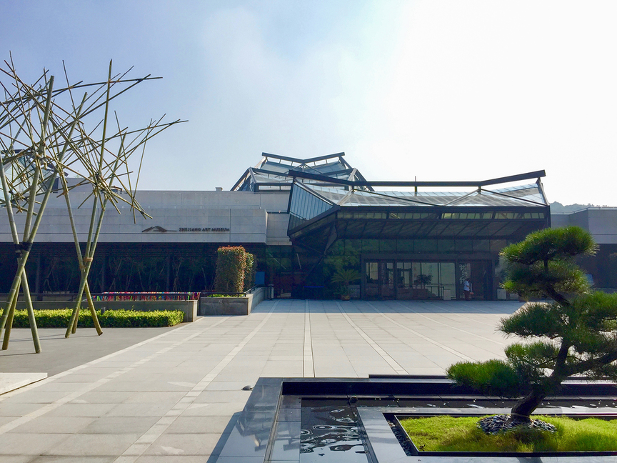 Exterior view of Zhejiang Art Museum in Hangzhou. To the left is the outdoor bamboo installation Mega Fabrication (2016) by ATELIER CHEN HAORU. All photos by Sylvia Tsai for ArtAsiaPacific.