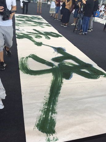 GU WENDA’s calligraphy work Verdant Mountains, Emerald Waters (2016), where he merged the characters for the phrase qingshan (“verdant mountain”) and lushui (“emerald waters”), creating not only a new algae-ink scroll, but also new Chinese characters. Photo by Cristina Sanchez-Kozyreva.