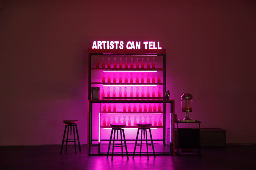 WANG XIN, Artists Can Tell, 2017, mixed-media installation with table, chair, signboard, LED light, custom bottles, Kool Aid, vodka, 240 × 210 × 210 cm. Courtesy De Sarthe Gallery, Hong Kong.