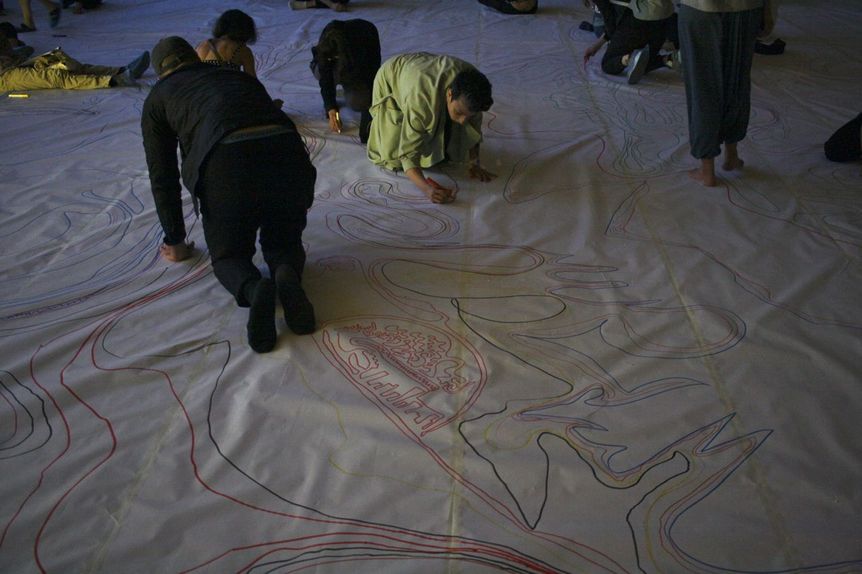 Audience members drawing the labyrinth for ONUR KARAOĞLU’s performance Minority Stress – Things I Think But Cannot Say.