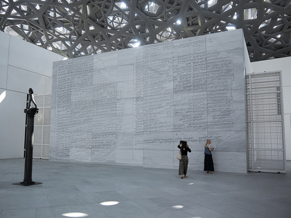 A sculpture by AUGUSTE RODIN is juxtaposed with a newly commissioned limestone relief by American artist JENNY HOLZER, one of three that is permanently installed around Louvre Abu Dhabi. This For the Louvre Abu Dhabi (2017) work relays a creation myth story written in bilingual Sumerian and Akkadian cuneiform script, taken from a Mesopotamian tablet that was excavated from the ancient city of Assur in present-day Iraq.