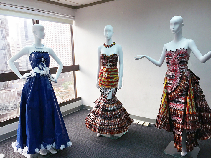 A standout piece at the exhibition was (centre) Mermaid Gown, 2014, for which ELPIE MALICSI painstakingly sewed together 310 coffee sachets and 36 chocolate wrappers, one by one, to form a full-length dress with a dramatic, tiered fishtail that holds its structure surprisingly well considering the typical flimsiness of plastic food packaging. This creation was flanked by (left) Blue Dress, 2016, and (right) Coffee Sachet Dress, 2014.