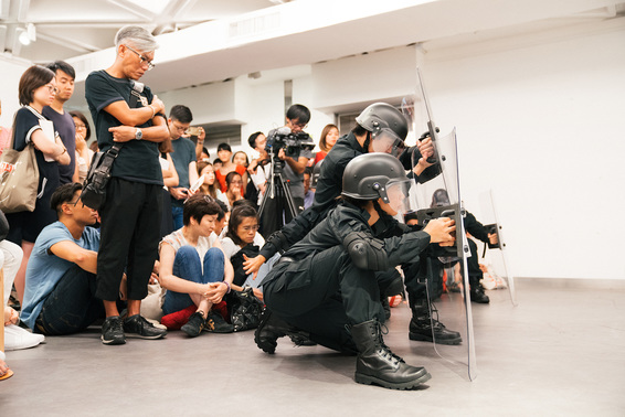 ISAAC CHONG WAI, Rehearsal of the Futures: Police Training Exercises, 2018, digital image of performance, dimensions variable, at “M+ Live Art: Audience as Performer,” Goethe-Institut, Hong Kong, 2018. Photo by CPAK Studio. ©M+, Hong Kong. Courtesy West Kowloon Cultural District Authority, Hong Kong.