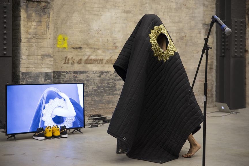 BASEERA KHAN, Acoustic Sound Blanket, 2017, documentation of live performance with acoustic sound blankets with gold embroidering, silk, felt and industrial sound insulation, 228.6 × 215.9 cm, at Gavin Brown’s Enterprise, New York, 2018, curated by Housing, New York. Photo by Filip Wolak. Courtesy the artist.