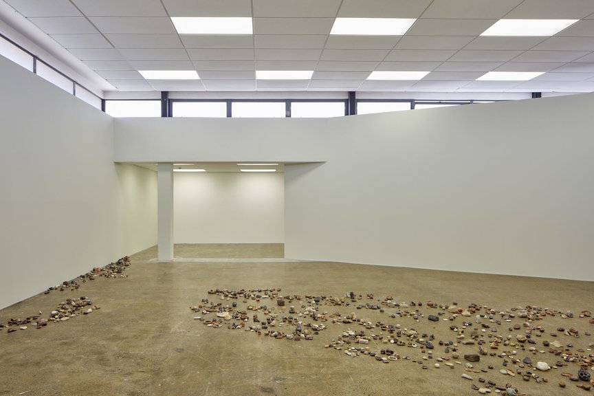 Installation view of Riverbed, 2018, wood-fired ceramic rocks, dimensions variable, made by workshop participants for FIONA JACK’s “Riverbed” at Artspace NZ, Auckland, 2018–19.