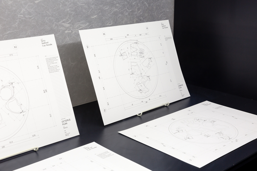 Detailed installation view of MINJA GU’s The Authentic Quality – Spicy Seafood Noodle, 2019, CAD drawings printed on A3 paper, 11 pieces, at “Take ( ) at Face Value,” Korean Cultural Centre Australia, Sydney, 2019. Photo by Documentary Photography. Courtesy the artist and Korean Cultural Centre Australia.