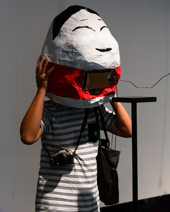 Photo of participant trying on DON’T FOLLOW THE WIND’s A Walk in Fukushima, 2015–17, 360 degree video, headsets, at “Sharp Chronicles,” the Microwave International New Media Arts Festival, Hong Kong City Hall, 2020. Courtesy the Festival.