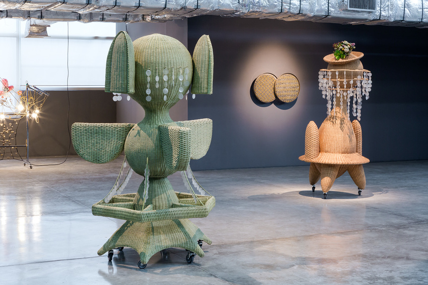 Installation view of HAEGUE YANG’s (from left to right) The Randing Intermediate – Open-Armed Long-Eared Monarch and The Randing Intermediate – Crested Duck King, both 2020, stainless steel frame, casters, wicker, nylon, cord, stainless steel rings, artificial plants, dimensions variable, at “The Cone of Concern,” Museum of Contemporary Art and Design (MCAD), Manila, 2020–21. Photo by At Maculangan. Courtesy MCAD.